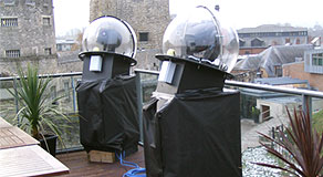 Weather-proof enclosure domes for intelligent lighting units for temporary roof top installation
